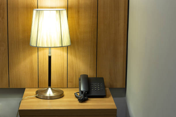 istock Table lamp and telephone on table in the bedroom 1398986092