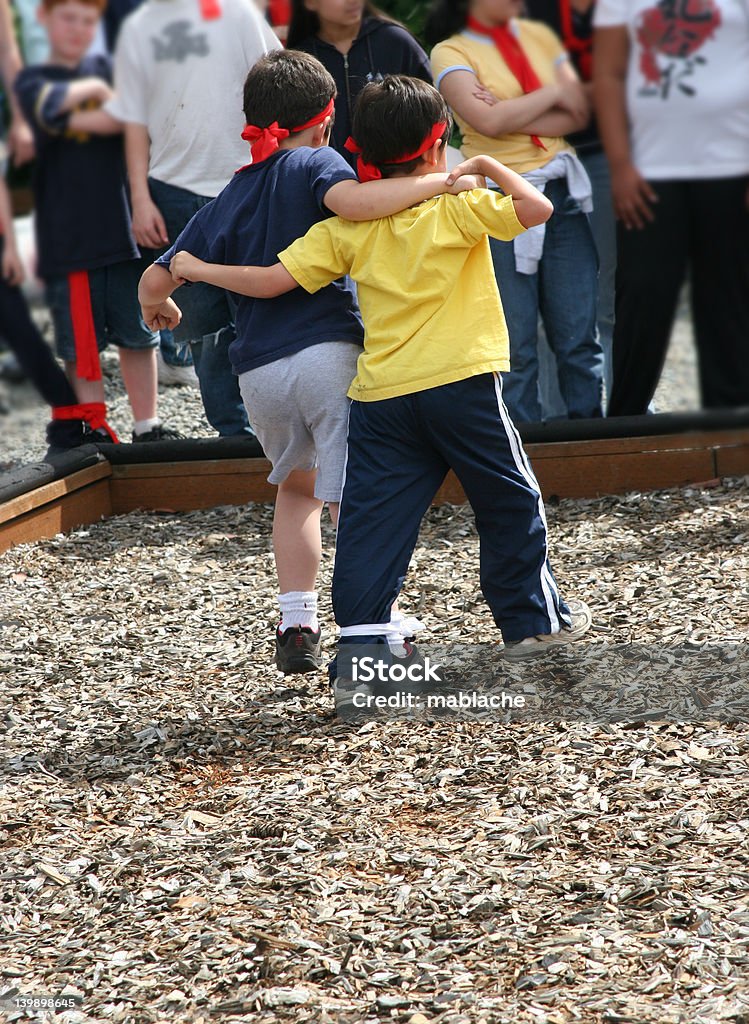 Three Legged Racers Two young boys in a three legged race Relay Stock Photo