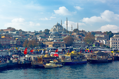 Eminönü, Istanbul / Turkey - November 15, 2021: people walk across the square and relax on Eminönü pier