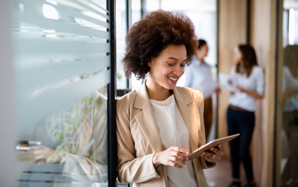 istock Portrait of young successful black woman working with tablet in office 1398986708