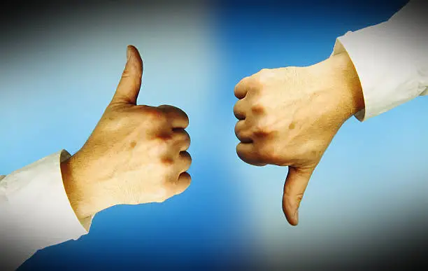 One hand with thumbs up, another with thumbs down. Blue background.