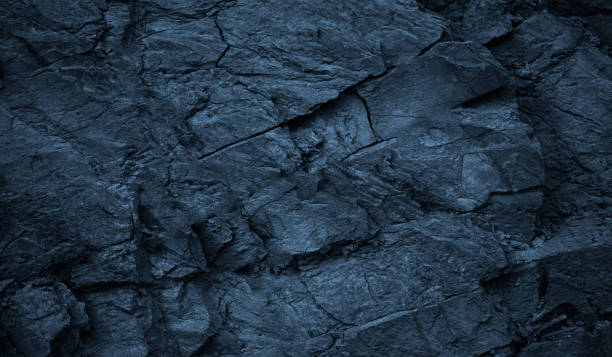 istock Dark blue rock texture. Toned rough mountain surface with cracks. Close-up. Stone background. 1398987003