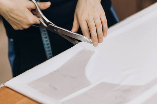 istock The tailor cuts out the fabric according to the pattern 1398987517