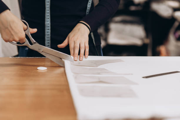 istock The tailor cuts out the fabric according to the pattern 1398987538