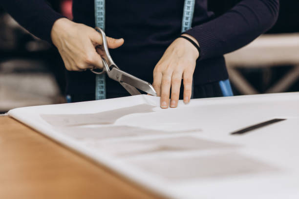 istock The tailor cuts out the fabric according to the pattern 1398988144