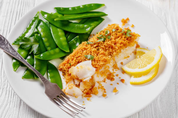 istock Baked Haddock with Crackers toppings and snow peas 1398988417