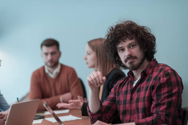 istock Successful team. Group of young multi-ethnic business people working and communicating together in creative office. Selective focus 1398988441