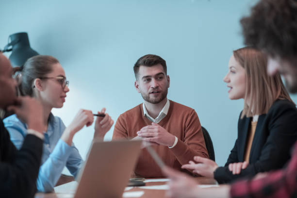 istock Successful team. Group of young multi-ethnic business people working and communicating together in creative office. Selective focus 1398988447