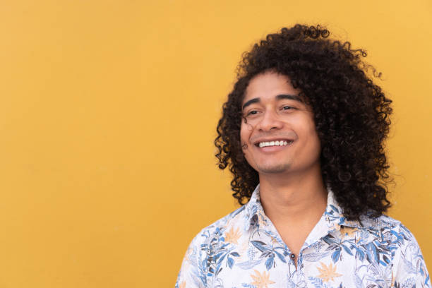 istock Smiling Man With Curly Hair In City 1398988932
