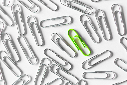 Multicolored paper clips on a white background