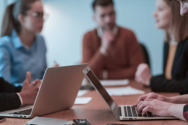 istock Successful team. Group of young multi-ethnic business people working and communicating together in creative office. Selective focus 1398989671