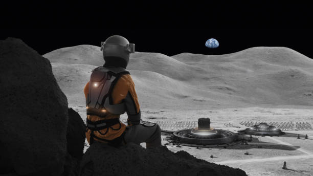 istock Astronaut stranded on the moon missing home. Distant planet Earth in the sky 1398989839
