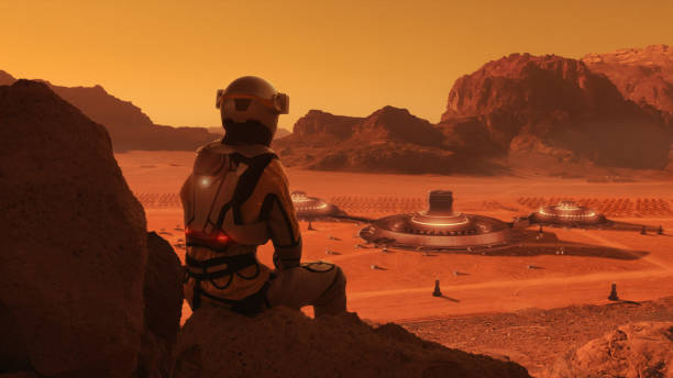 istock Astronaut on planet Mars watching a space station. Earth colony in Space 1398989847