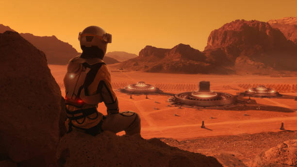 istock Astronaut on planet Mars watching a space station. Earth colony in Space 1398989851