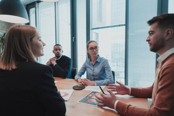 istock Successful team. Group of young multi-ethnic business people working and communicating together in creative office. Selective focus 1398990928