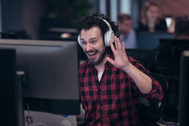 istock Funny businessman wearing headset having virtual team meeting group call chatting with diverse people in customer support. Video conference call on computer with manager and employees. 1398991187