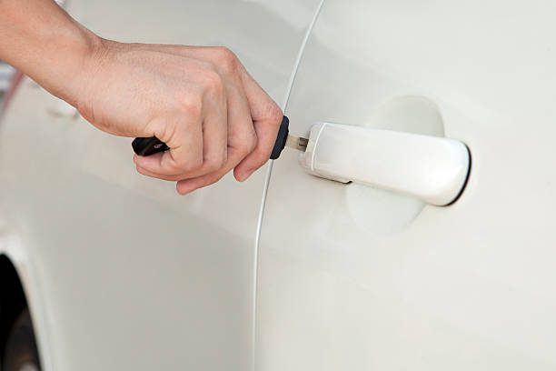 istock Person Inserting Car Key in door lock 139899154
