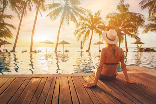 travel, woman in luxury beach hotel at sunset, vacation trip travel, woman in luxury beach hotel at sunset, vacation trip, tourism beach holiday stock pictures, royalty-free photos & images