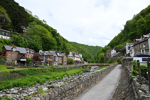 20 May 2022: Lynmouth, Devon, England, UK - A view of the River Lyn and Mars Hill on a sunny day.  Coastal village of Lynmouth in Devon on the northern edge of Exmoor National Park.