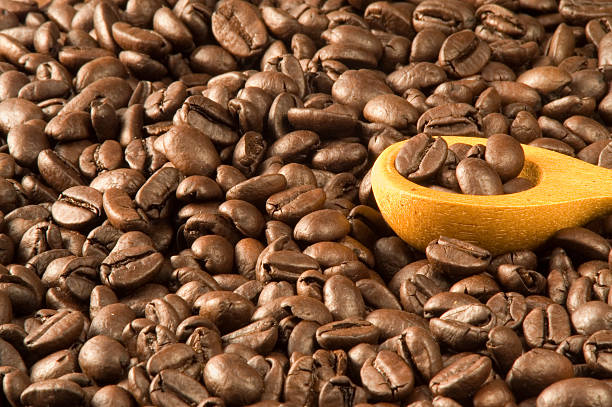 Wood spoon in coffee beans stock photo