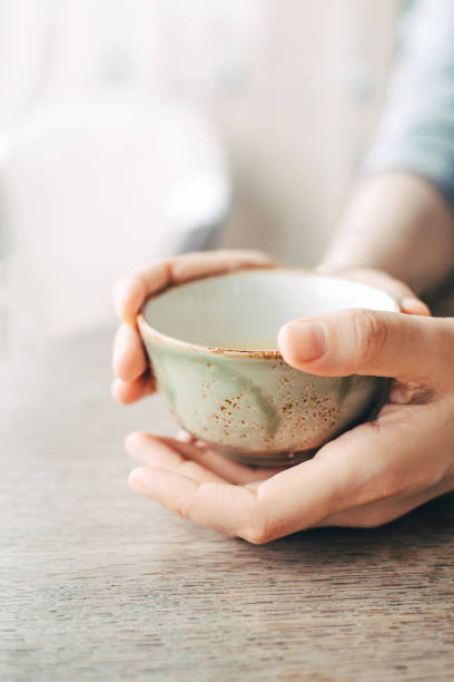 istock Women's hands hold a cup of tea. 1398992729