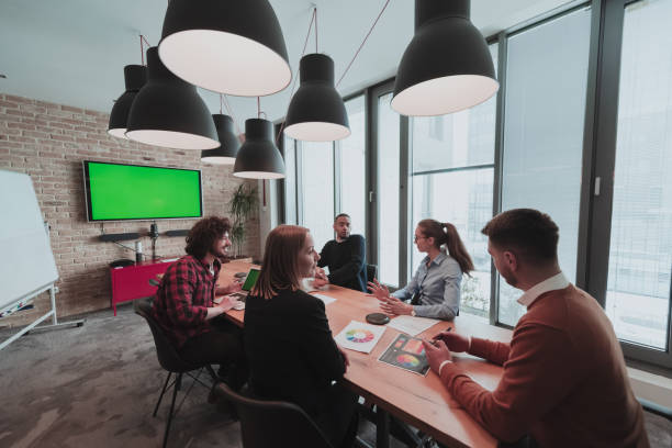 istock Successful team. Group of young multi-ethnic business people working and communicating together in creative office. Selective focus 1398993426