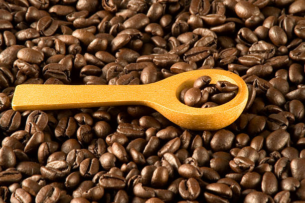 Spoon in coffee beans stock photo