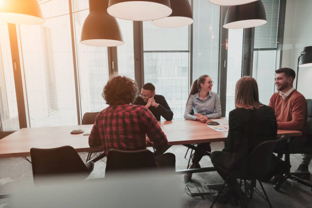 istock Successful team. Group of young multi-ethnic business people working and communicating together in creative office. Selective focus 1398995210