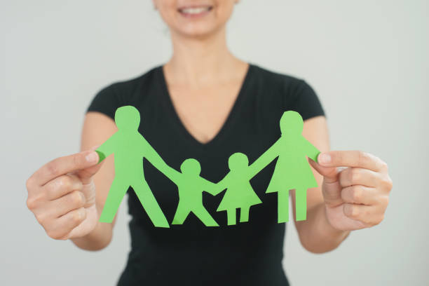 Broken family symbol separating father from mother and children is a concept for today's family problems where divorce is on the rise.