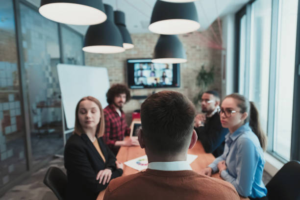 istock Successful team. Group of young multi-ethnic business people working and communicating together in creative office. Selective focus 1398995782