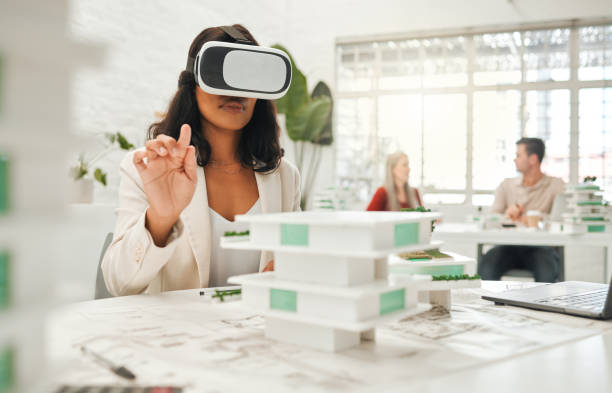 istock African american architect using ai headset.businesswoman playing a game on a VR headset. Designer using game gadget to watch architecture videos. Businesswoman watching a simulation in VR goggles 1398996875