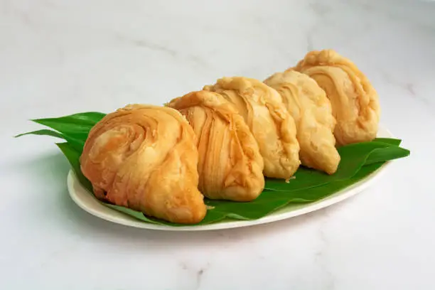 Photo of Malaysia popular and traditional snack Karipap filled with potato fillings.