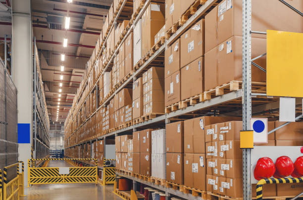 istock Industrial distribution, composition. Storage with high shelves, cargo boxes on racks. Rows of shelves with boxes at the factory. 1398998198