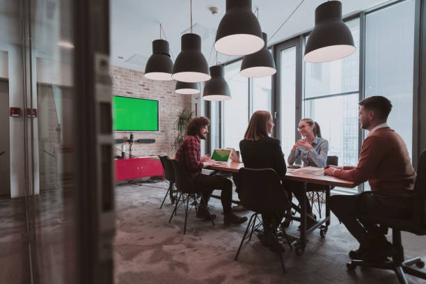 istock Successful team. Group of young multi-ethnic business people working and communicating together in creative office. Selective focus 1398998308