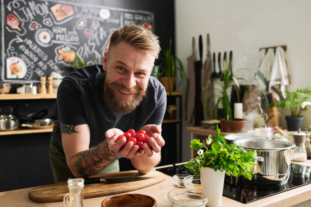 istock Tattooed Man With Cherry Tomatoes 1398998731