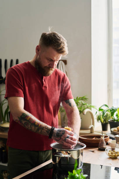 istock Young Adult Man Cooking Pasta 1398999634