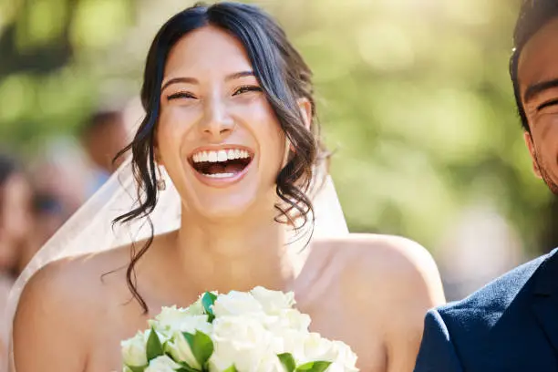 Photo of Close up of a happy beautiful bride laughing and having fun on her wedding day. Face of joyful bride enjoying her dream wedding