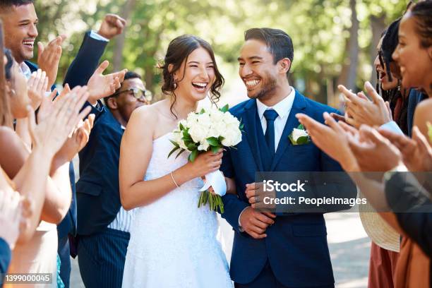 Wedding Guests Clapping Hands As The Newlywed Couple Walk Down The Aisle Joyful Bride And Groom Walking Arm In Arm After Their Wedding Ceremony Stock Photo - Download Image Now