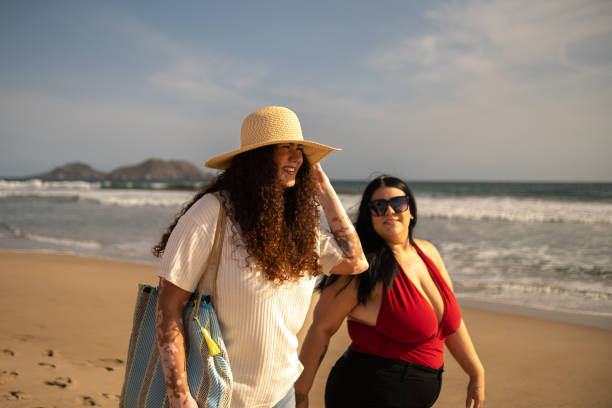 istock Friends talking and walking on the beach 1399001042