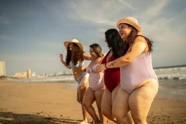 istock Excited friends enjoying day in the beach 1399001374