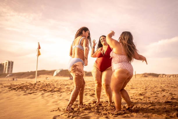 istock Young women having fun on the beach 1399001471
