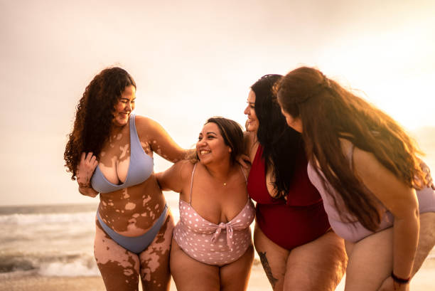 istock Young women embracing on the beach 1399001487