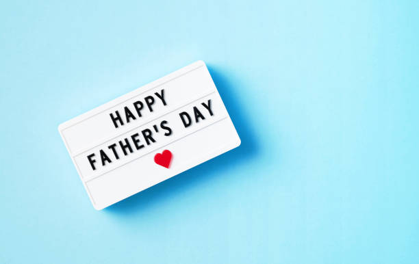 istock Happy Father's Day Written White Lightbox Sitting On Blue Background 1399001505