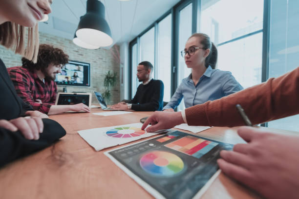 istock Successful team. Group of young multi-ethnic business people working and communicating together in creative office. Selective focus 1399001524