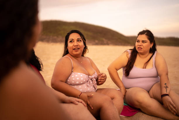 istock Young women talking on the beach 1399001573