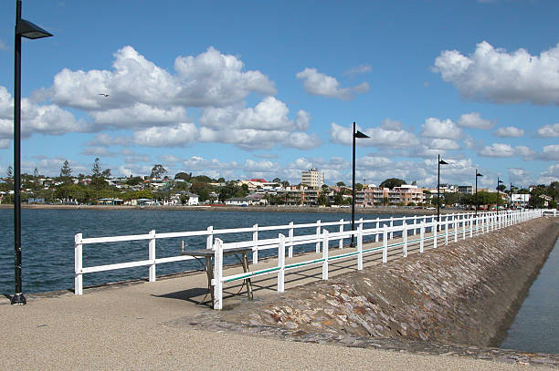 Jetty, Looking Shoreward This long quiet jetty at Wynnum, Brisbane, Queensland, Australia is decorated with mosaic telling lore of the local Aboriginal people. wynnum stock pictures, royalty-free photos & images