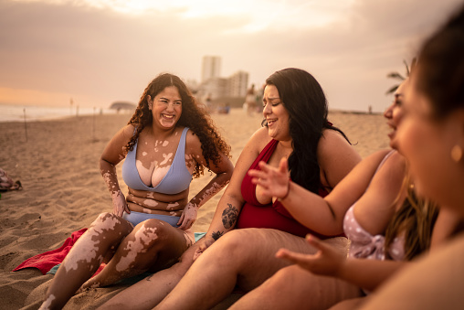 Young women talking on the beach