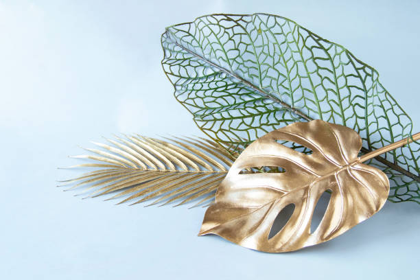 istock Golden Monstera and palm leaf of design 1399003366