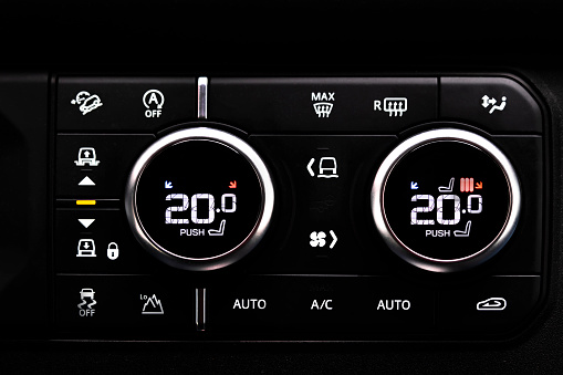 Selective focus of Vehicle Air Conditioning Control System. AC Recirculation Button on dashboard in luxury car.