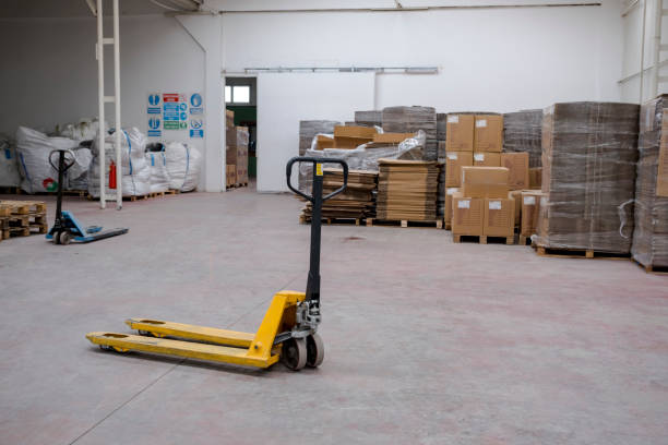 hand pallet truck hand pallet truck, in the warehouse part of the factory. Selective Focus pallet truck pallet jack handle stock pictures, royalty-free photos & images